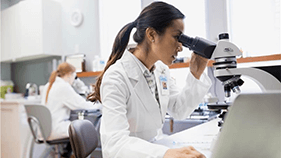 Scientist Looking into a Microscope