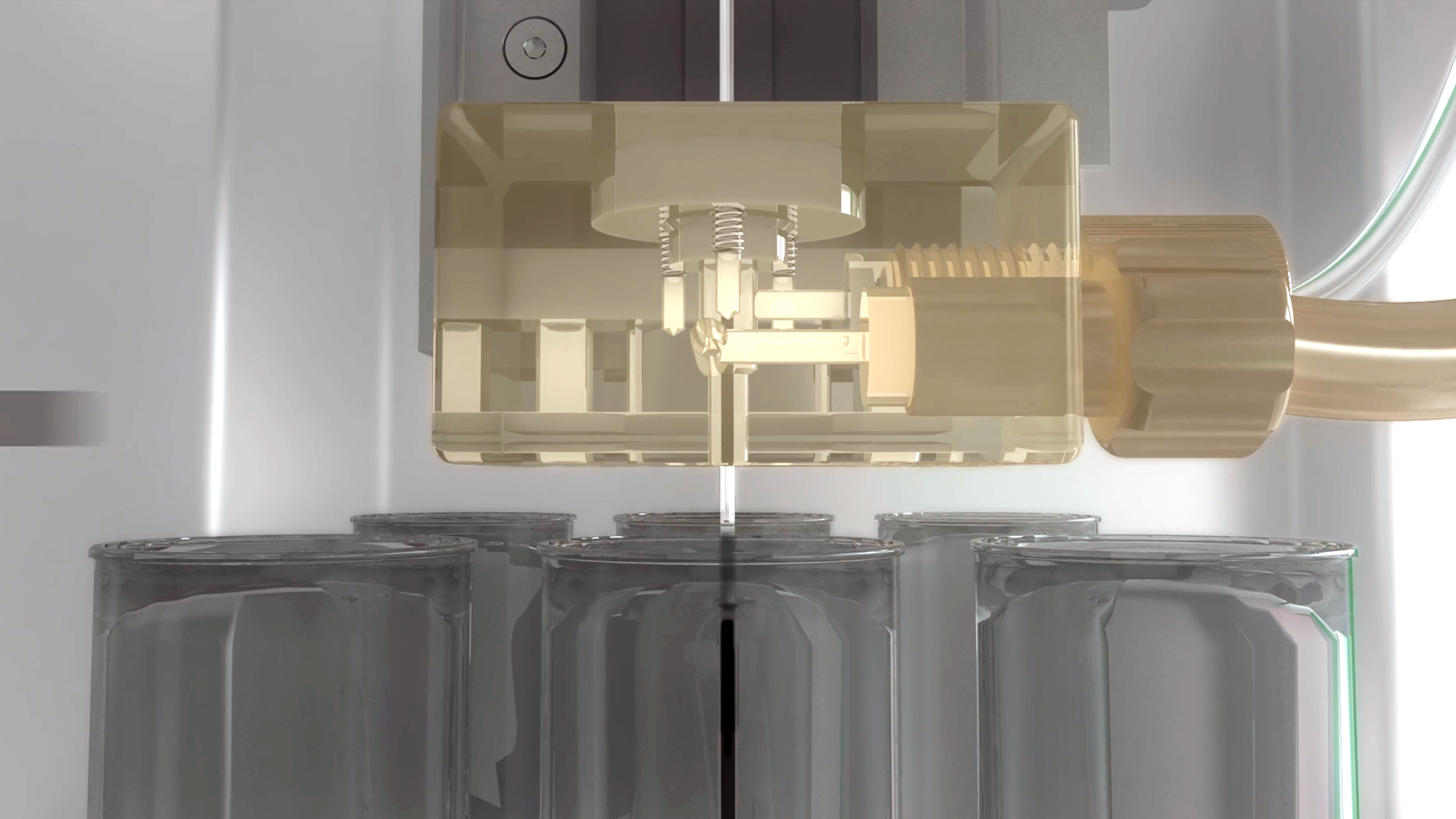 Close-up of an industrial machine filling glass jars with precision