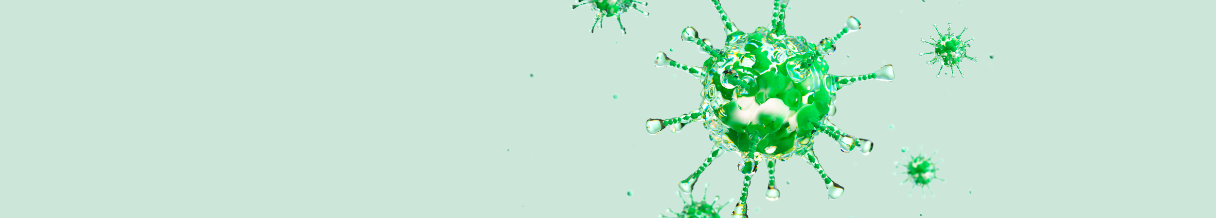 Scientific illustration of green and translucent virus or cancer cells.