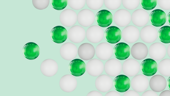 Green and white translucent spheres are scattered on a light teal background.