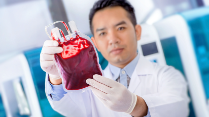 Scientist Holding a Pouch of Blood
